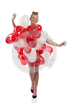 Blonde girl with many balloons on her body
