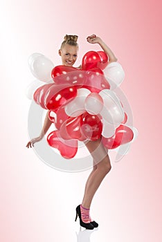 Blonde girl with many balloons on her body