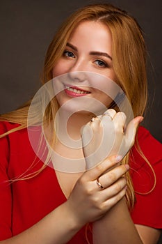 A blonde girl with an overweight plus size, in a red overallposing on a dark Studio background
