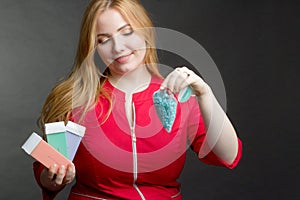 A blonde girl with an overweight plus size, in a red overallposing on a dark Studio background