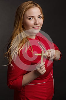 A blonde girl with an overweight plus size, a red overallposing on a dark Studio background