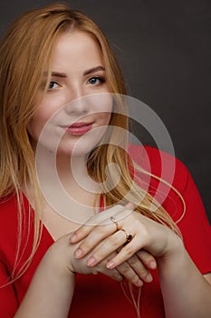 A blonde girl with an overweight plus size, a red overallposing on a dark Studio background