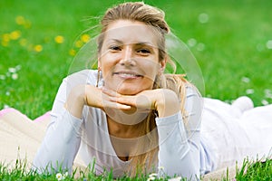 Blonde girl in park relaxing