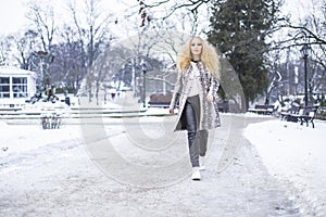 Blonde girl in the park on a winter day