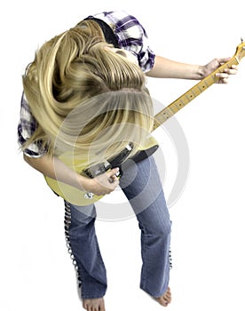 Blonde girl playing guitar in blue jeans and a plaid shirt