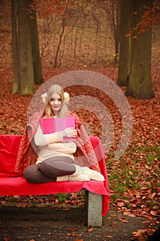 Blonde girl with red book.