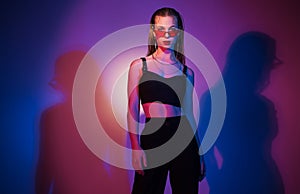 blonde girl in red glasses posing in the studio