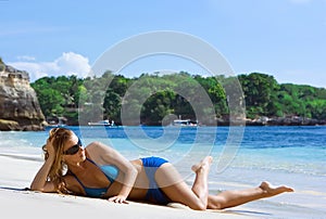 Blonde girl relaxing in water on the beach