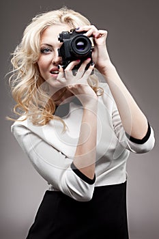 Blonde girl with retro camera