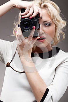 Blonde girl with retro camera