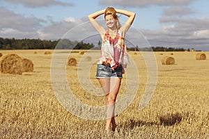 Blonde girl in sloping field