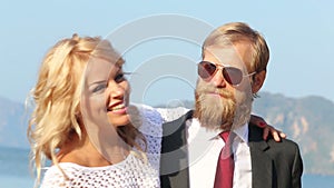 Blonde girl smiles and then cries on guitarist's shoulder