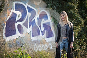 Blonde girl in the street in front of murals