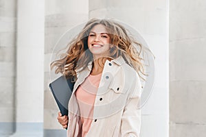 Blonde girl student jumping for joy. Girl successfully passed the exam, education concept