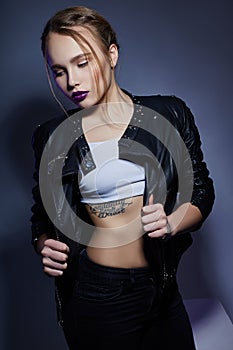 blonde Girl with tattoo in leather jacket and jeans, portra