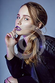 blonde Girl with tattoo in leather jacket and jeans, portra