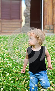 Blonde girl walking on grassplot photo