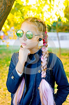 Blonde girl wearing a sunglasses with pink kanekalon in hair in