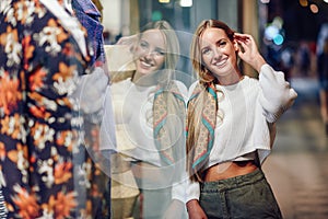 Blonde girl smiling with defocused urban city lights at night