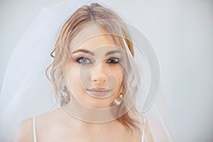 Blonde girl in a wedding dress Bride in a white dress. Makeup. photo