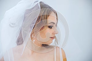 Blonde girl in a wedding dress Bride in a white dress. Makeup. photo