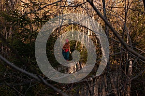 Blonde girl in the wild autumn forest