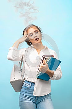 Blonde in glasses holds books in hands