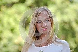 Blonde on a green background portrait