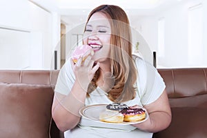 Blonde hair woman eats donut