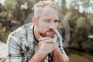 Blonde-haired man feeling unsure about making serious life changing decision