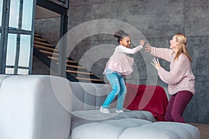 Blonde-haired mom and her foster child dancing and laughing