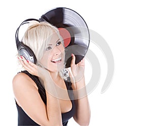 Blonde in headphones with vinyl record over white