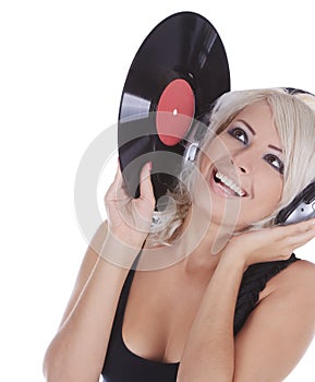Blonde in headphones with vinyl record over white