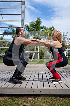 Blonde lady exercising with her personal trainer