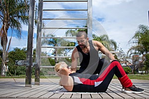 Blonde lady exercising with her personal trainer