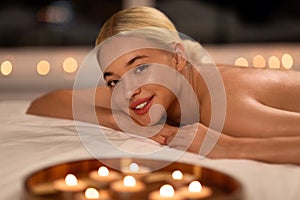 blonde lady lying on massage desk after bodycare treatment indoors