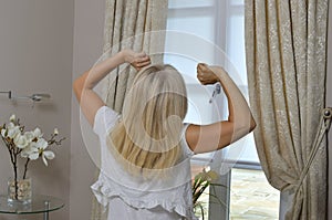 Blonde Lady Stretching in Bedchamber
