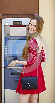 Blonde lady using an automated teller machine