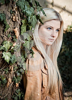 Blonde leaning on Tree