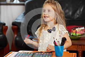 Blonde little girl learning the make-up