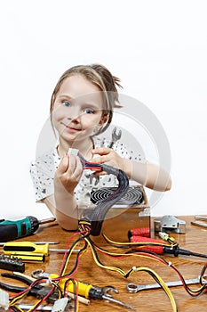 Blonde little girl repair a computer component