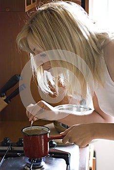 Blonde making coffee