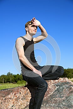 Blonde male looking directly at the sun