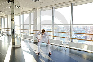 Blonde male person spotting in white suit.