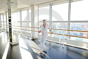 Blonde male person spotting in white suit.