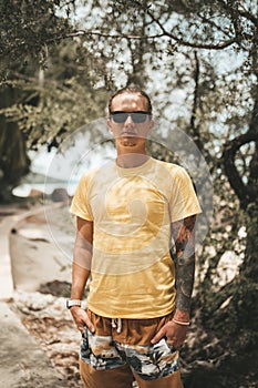 Blonde man with pony tail standing on the beach