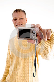 Blonde man showing digital camera