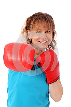 Blonde mature woman with boxing gloves punching