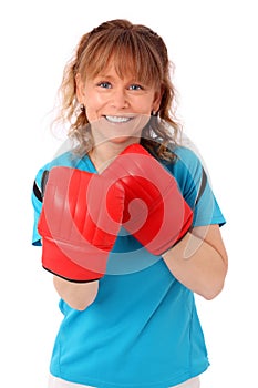 Blonde mature woman with boxing gloves punching