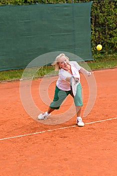 Senior woman playing tennis